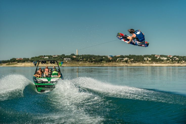 boat on lake with wakeboarder