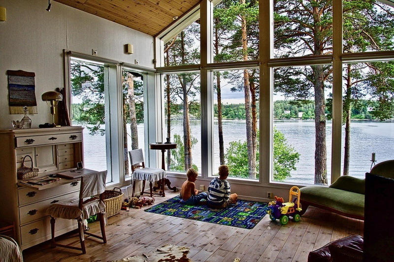 interior of cabin with bay windows and children playing