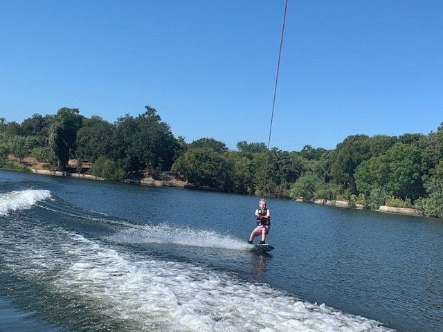 person wakeboarding on a river