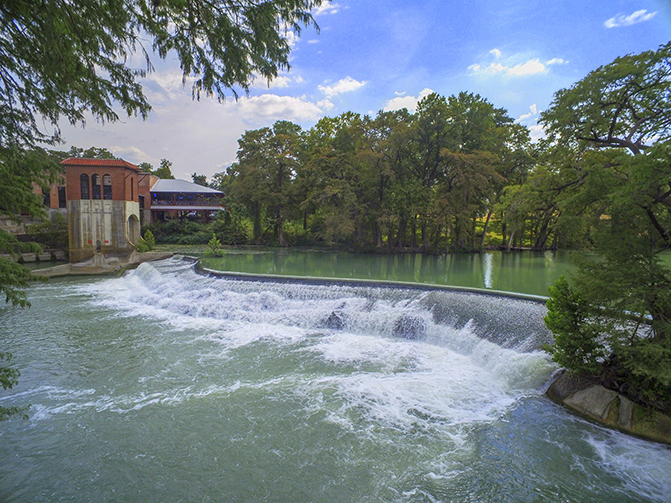 river dam with building and forest